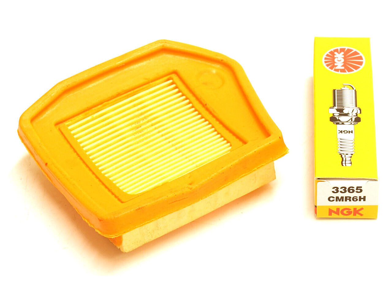 Orange air filter to suit Stihl brushcutter models FS240 FS260 FS360 FS410 FS460 FR410 FR460 with an NGK CMR6H spark plug laying beside it