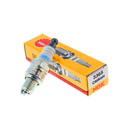 An NGK CMR6H spark plug laying on its box